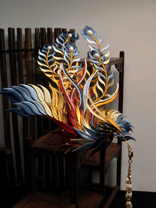 A fully assembled traditional Chinese phoenix hairpin, made from colorful silk threads, displayed on a small wooden stand.
