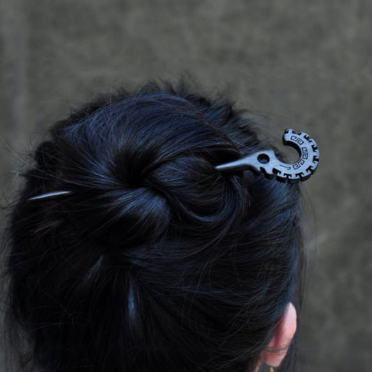 Natural African Blackwood hair stick "Jie Jie Shou" 18cm worn in a low bun on long dark hair.