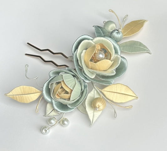 Finished Old Dream Chanhua hairpin featuring blue and yellow silk-wrapped flowers with green leaves, a handmade DIY flower project.
