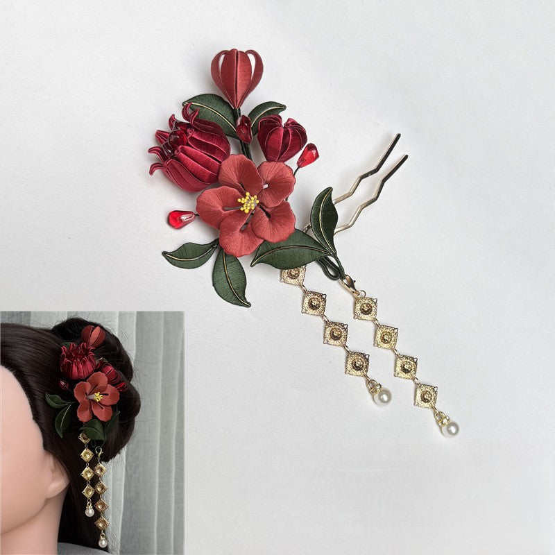 DIY Chanhua kit featuring silk-wrapped pomegranate flowers and green leaves with a gold hairpin base on a white background.