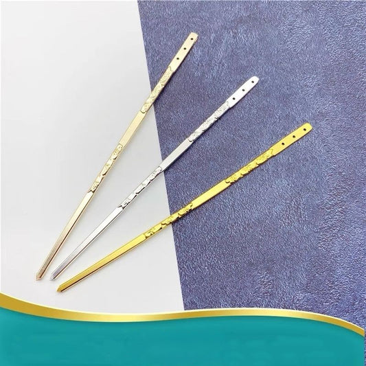 Set of silver and gold engraved hair sticks arranged on gradient surface, versatile for DIY hair accessory essentials.