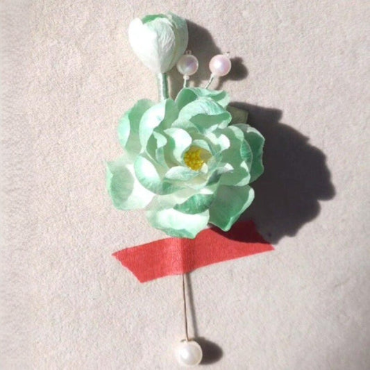 3D velvet flower pin depicting a blooming green hibiscus made with traditional artisanal techniques.