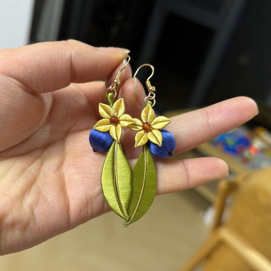 Handmade Chanhua blueberry earrings with blue silk berries, golden flowers, and green leaves