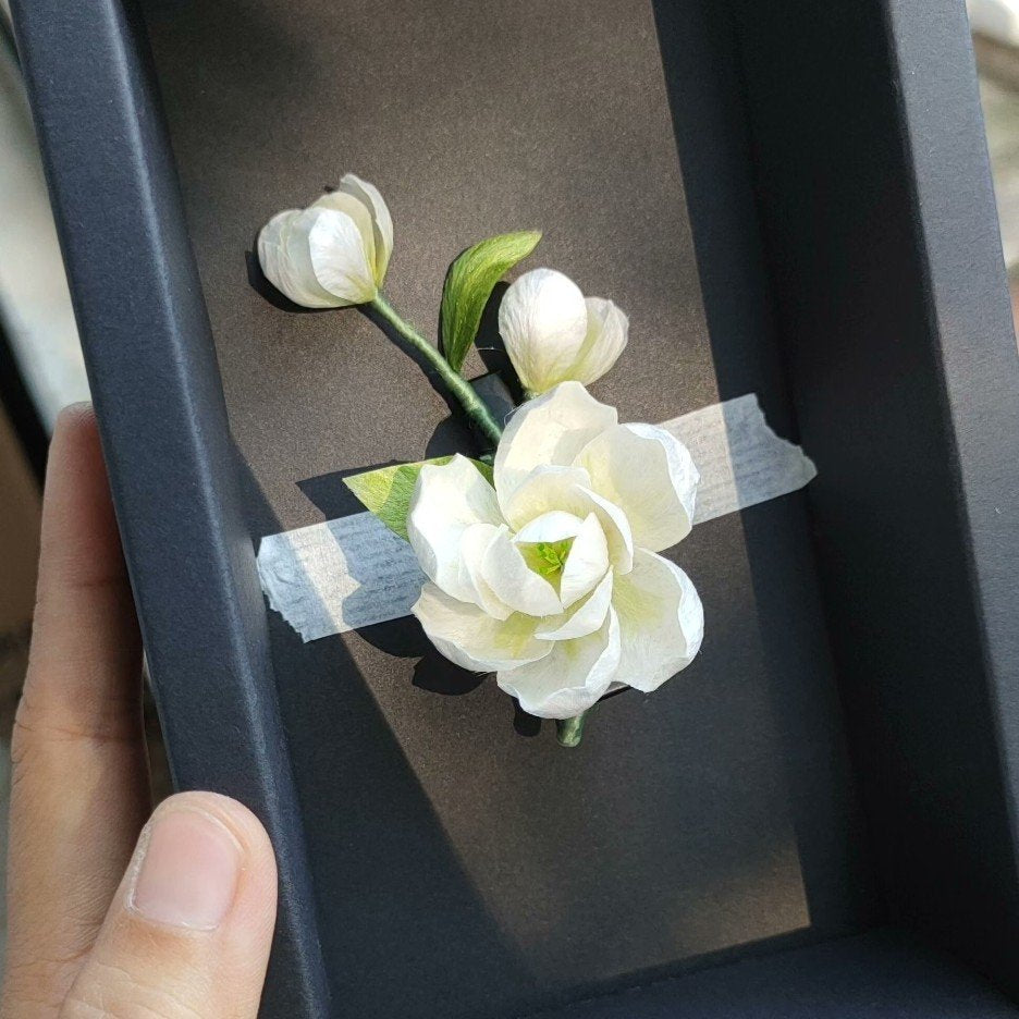 3D silk velvet floral lapel pin depicting blooming jasmine flowers made with traditional artisanal Ronghua techniques.