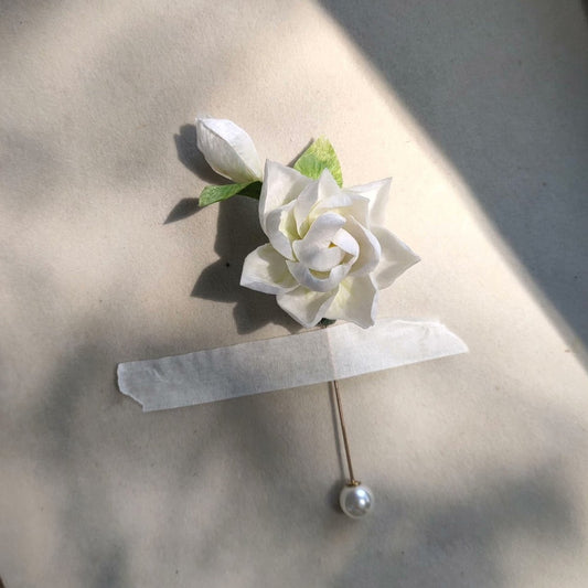 3D silk velvet flower pin depicting a blooming white gardenia made with traditional artisanal Ronghua techniques.