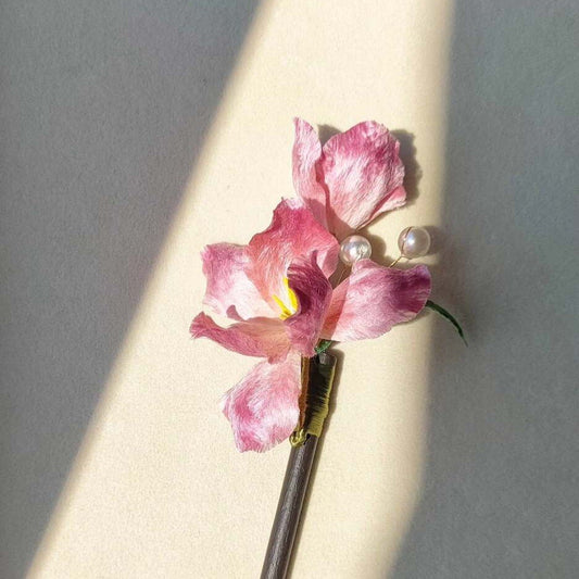 3D silk velvet flower hair accessory depicting a blooming pink iris made with traditional artisanal Ronghua techniques.