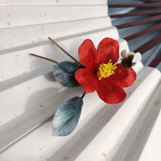 3D silk velvet flower hair accessory depicting a blooming red camellia made with traditional artisanal Ronghua techniques.