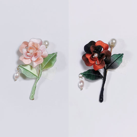 Chanhua handmade mini rose brooches in pink and dark red, each with a pearl center and pearl drop pendant on the stem, displayed on a light gray background