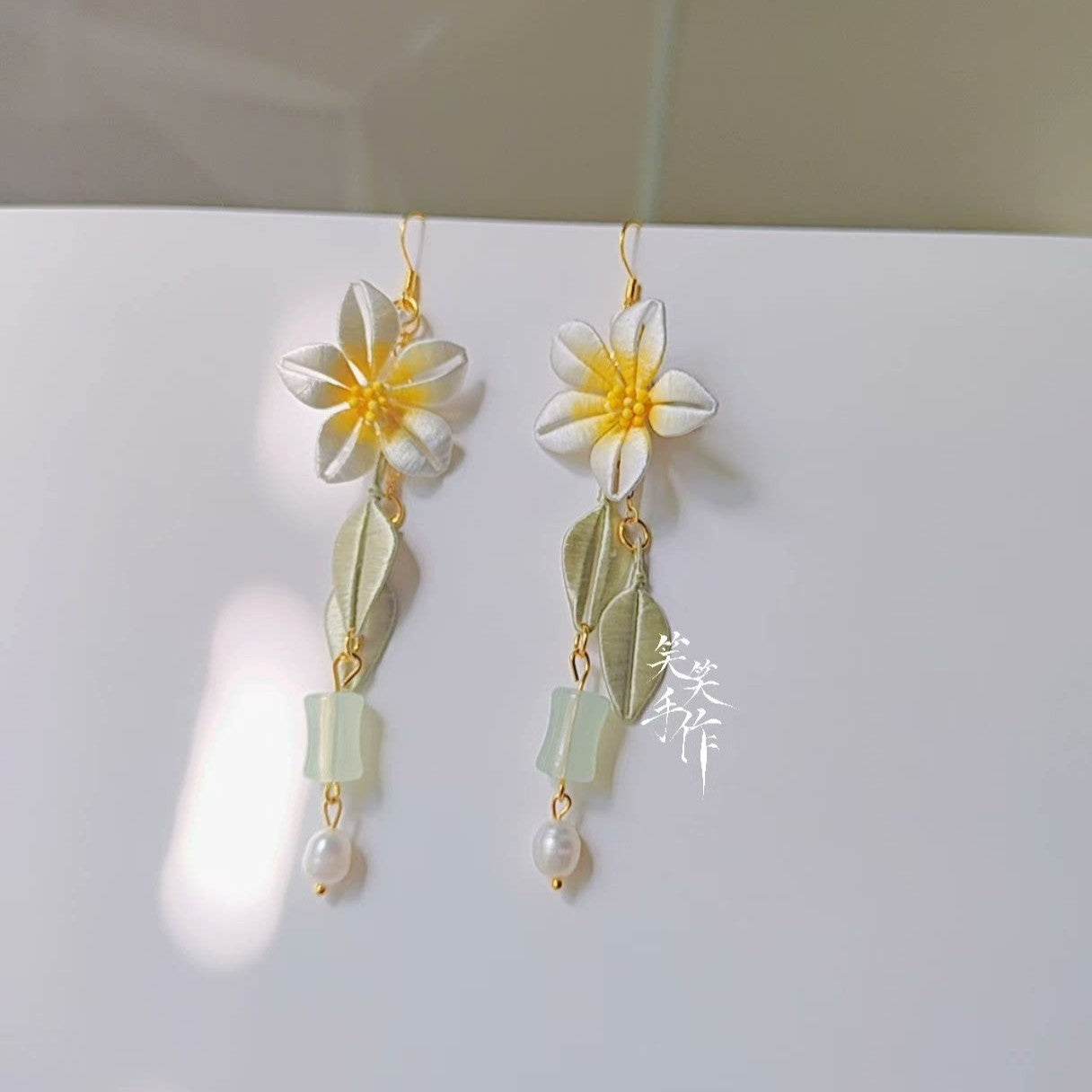 Elegant Chanhua floral dangle earrings featuring 925 silver hooks, natural freshwater pearls, and delicate fabric flowers.