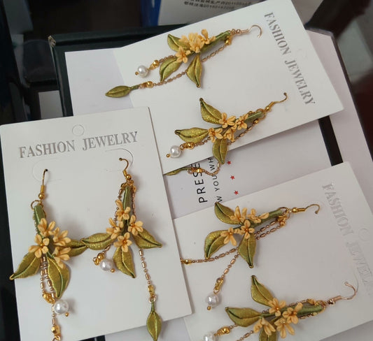 A collection of handmade Chanhua flower earrings displayed on white "Fashion Jewelry" cards.
