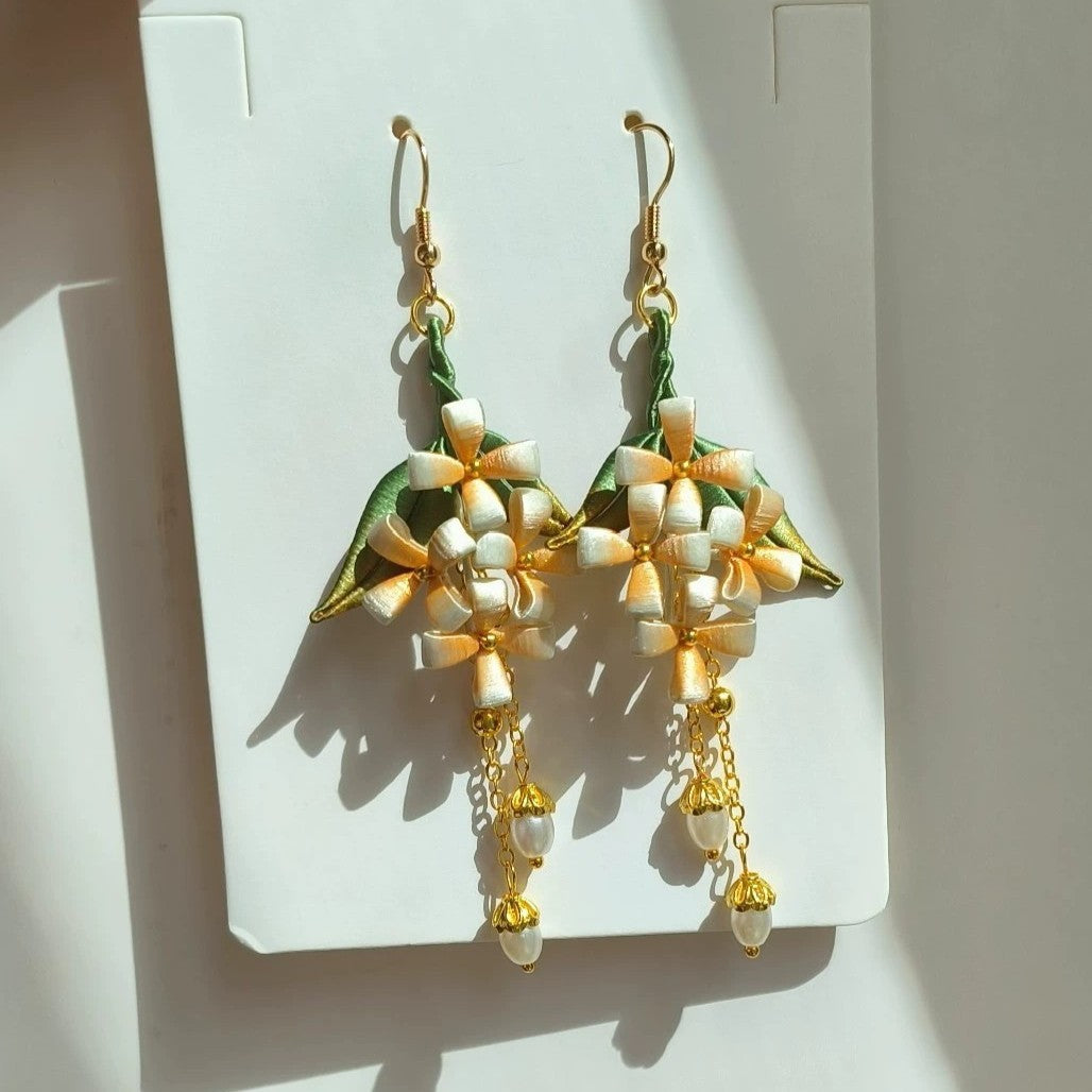 Close-up shot of the handmade Chanhua flower design on the elegant earrings, highlighting the detailed craftsmanship.