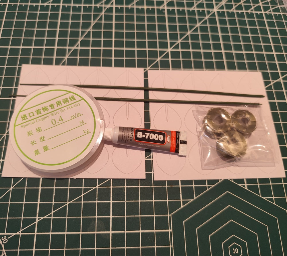 DIY flower craft supply kit featuring green velvet threads, copper wire, glue, stem wires, and paper templates for eucalyptus leaves.