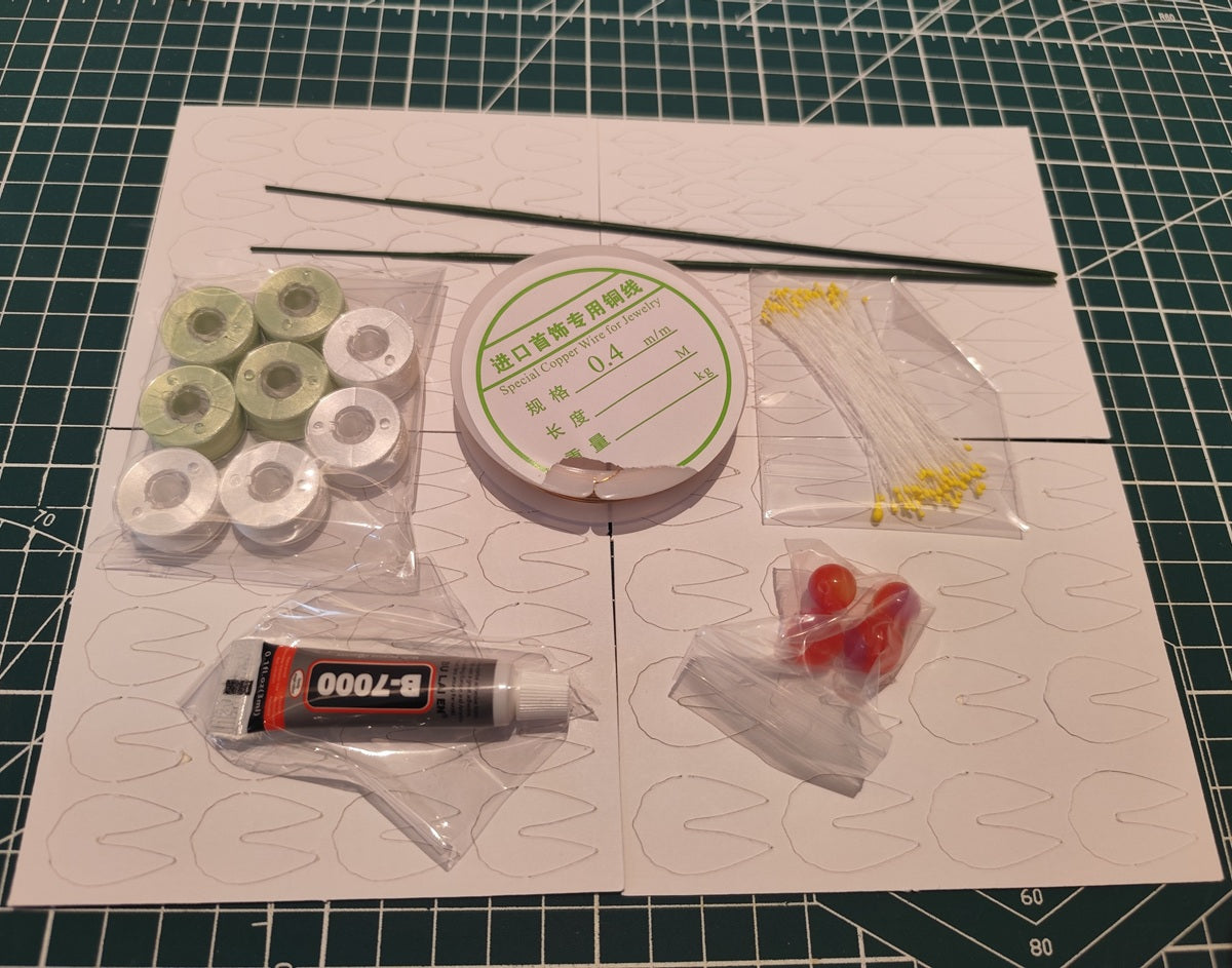 Contents of the Crabapple Chanhua DIY flower kit, including velvet threads, copper wire, glue, and paper templates.