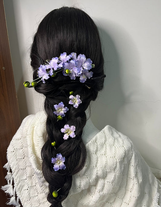 Closer view of the handcrafted silk Ronghua Crape Myrtle flower set securing a loose braided updo, highlighting the intricate floral details.