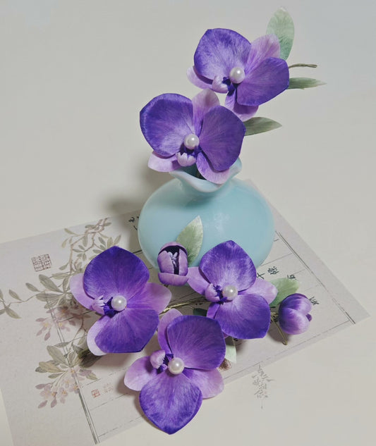 Handmade Ronghua purple phalaenopsis orchid hairpin set – large and small mulberry silk velvet orchids with pearl centers displayed with vase