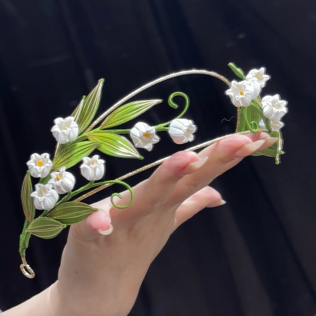 Handmade Lily of the Valley thread-wrapped Chanhua hair crown with white bell flowers and green leaves, an intricate DIY project for experienced floral artists.