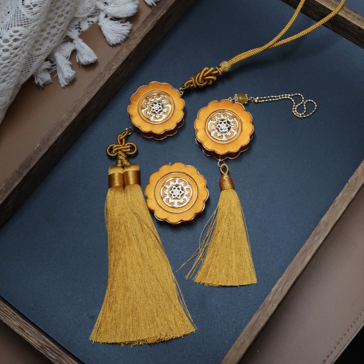 Handmade DIY mooncake hanging ornament kit featuring yellow thread-wrapped Chanhua floral design with golden tassels for home and car decor.