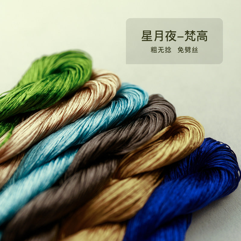A close-up, angled shot of a set of six thick, untwisted mulberry silk threads from the "Starry Night" (星月夜) collection, showing a palette of greens, blues, and earthy tones.