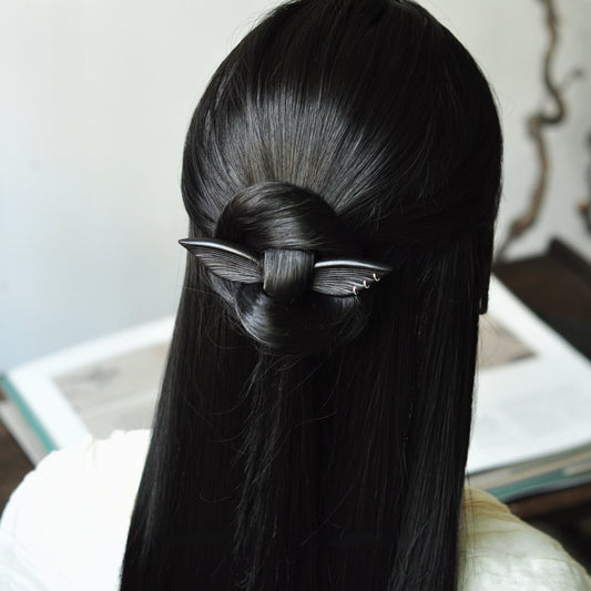 Natural African Blackwood hair stick "Xuan Zhi Yi" 13cm worn in a low bun on long black hair.