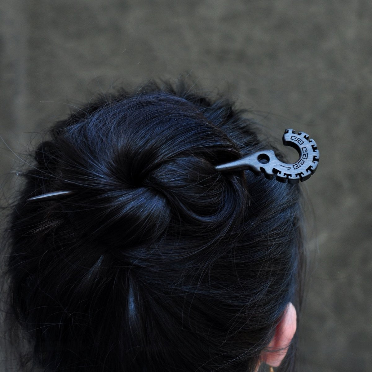 Natural African Blackwood hair stick "Jie Jie Shou" 18cm worn in a low bun on long dark hair.
