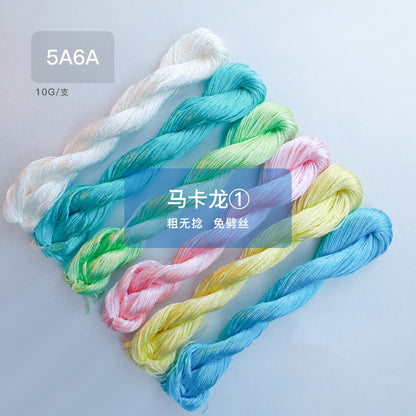 A set of six 10g skeins of thick, no-split mulberry silk thread in Macaron color palette 1, featuring soft pastel shades of blue, pink, yellow, and green.