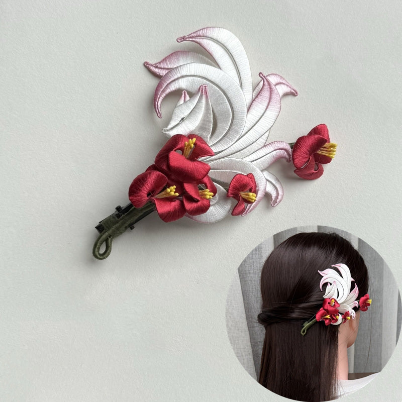 The finished nine-tailed fox Chanhua hairclip displayed with an elegant, dangling pearl and red bead accessory.