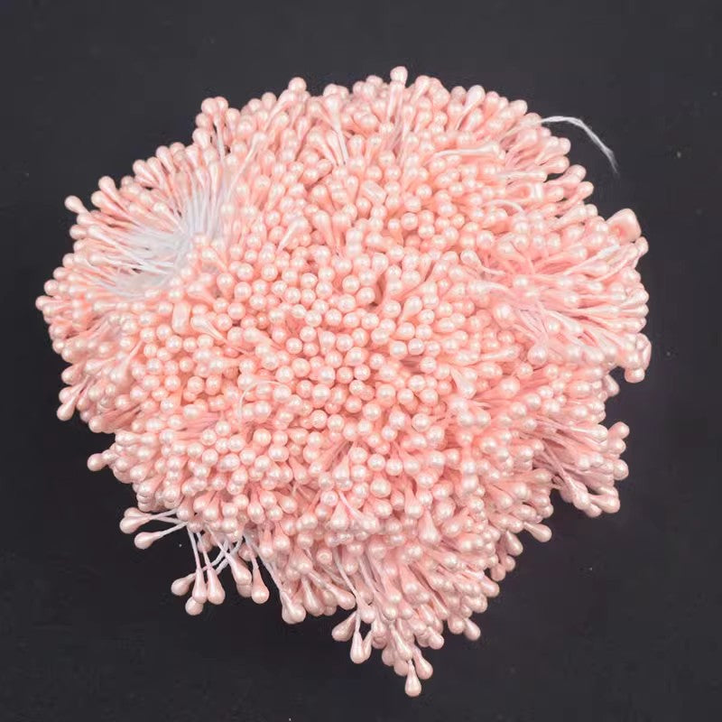 Close-up of a bundle of light pink 3mm glossy artificial flower stamens, highlighting the detailed, round tips and glossy finish.
