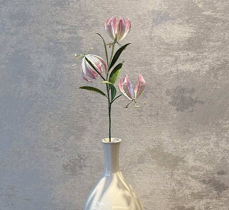 Finished pink and white Gloriosa Lily flower stem made from the DIY Chanhua velvet flower kit, displayed in a white vase.
