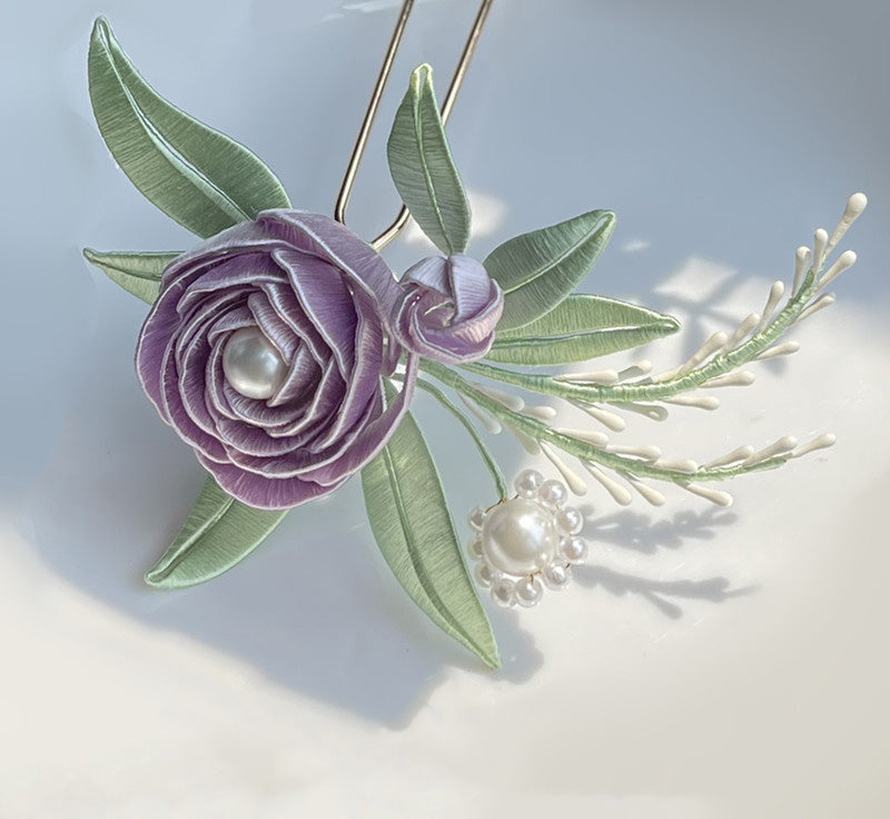 DIY Chanhua kit featuring a handcrafted purple silk-wrapped flower hairpin with green leaves and pearl details.