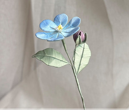 Close-up of a handmade blue Statice flower with gradient petals standing upright for vase display, made from silk threads.