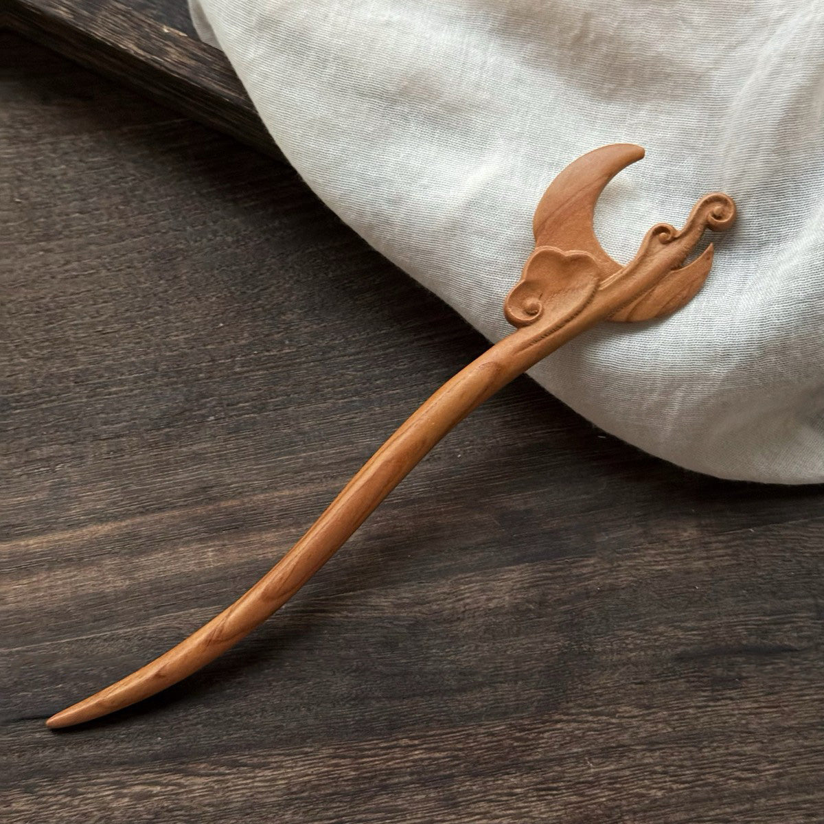 Natural peach wood 20cm hair stick with spring autumn moon cloud design on dark wooden background