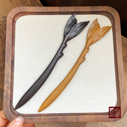 Set of two natural African blackwood 18cm hair sticks with fish tail design displayed in wooden tray