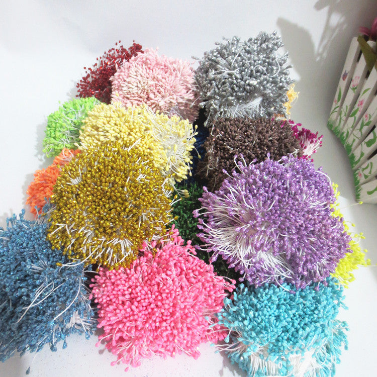An overhead view of many colorful bundles of fuzzy, matte-textured artificial stamens in various colors, including red, blue, green, and yellow.