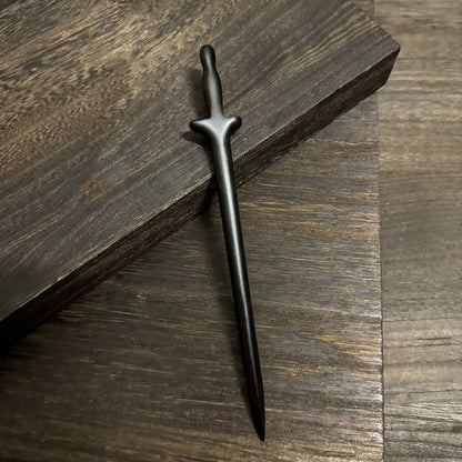 Natural African blackwood 18cm hair stick with immortal sword design on dark wooden surface