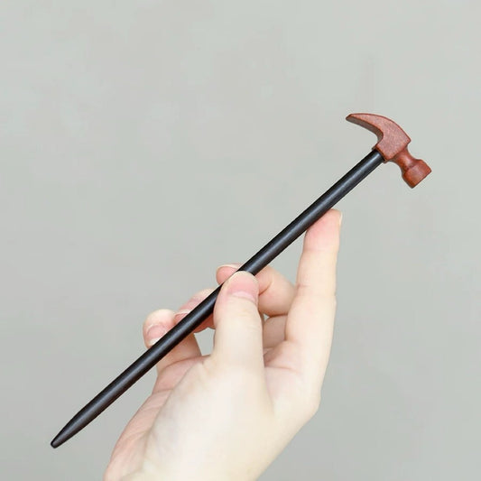 Natural African blackwood and padauk hair stick with hammer shape design held in hand