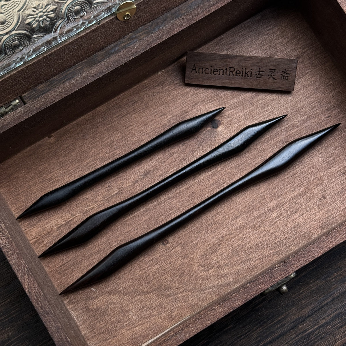 Three hand-polished African Blackwood hair sticks featuring a symmetrical, double-pointed martial arts design, displayed in a row.