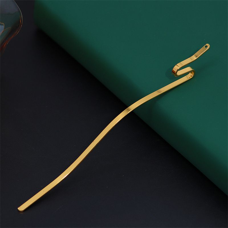A single serpentine metal hair stick in a gold finish with a wavy body and pierced top for DIY crafts.
