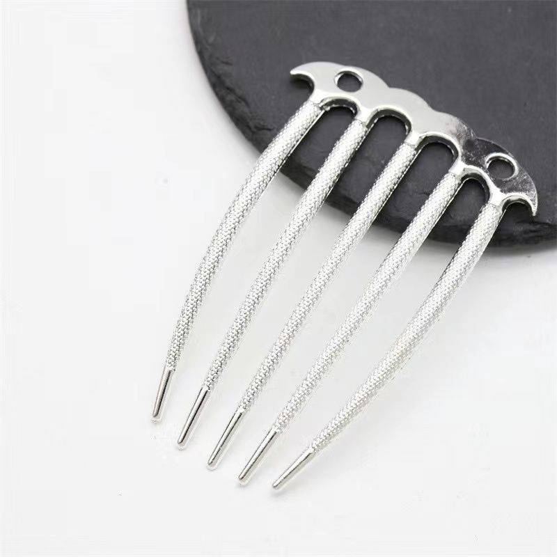 A silver-tone 5-prong hair comb finding with a non-slip texture for securing updos.