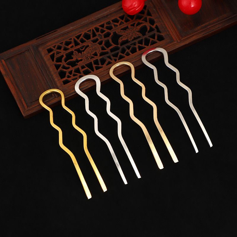 A set of three gold wavy two-prong hair forks for making DIY hair accessories.