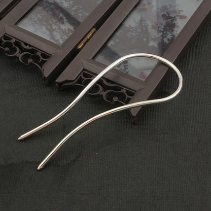 A single 110mm silver alloy minimalist hair fork, showing its clean lines and arch shape.