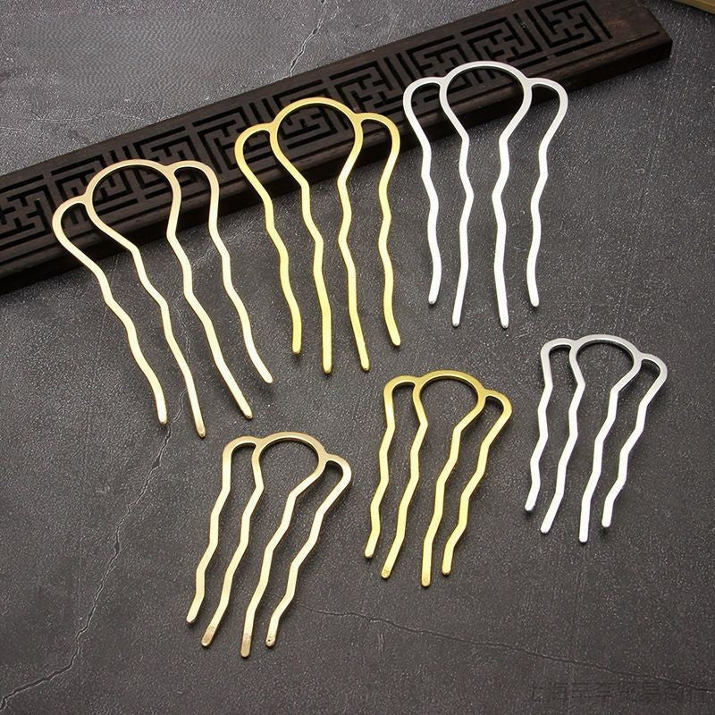 Set of gold and silver four-prong hair pins on a textured surface, highlighting their versatility for updos and craft use.