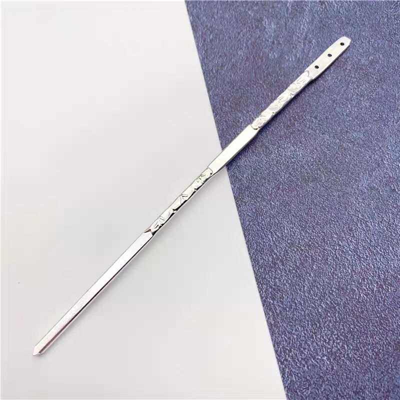 Close-up of a silver engraved alloy hair stick, 150mm long with floral patterns and end holes, displayed on white background for DIY use.
