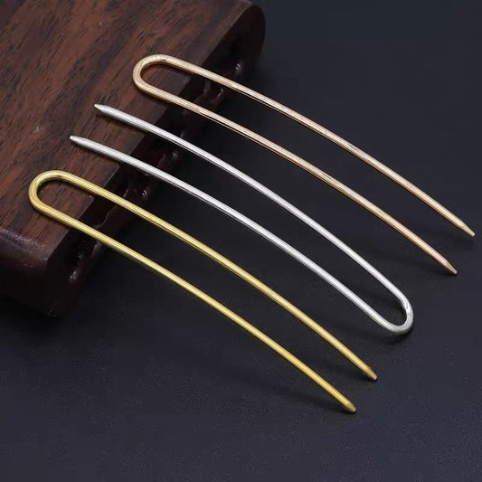 Set of 2-prong U-shaped alloy hair pins in gold, silver, and rose gold, arranged on wooden surface for DIY hair accessory use.