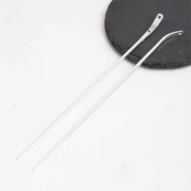 A pair of silver curved metal hair sticks, showing the blank base design for handmade accessories.
