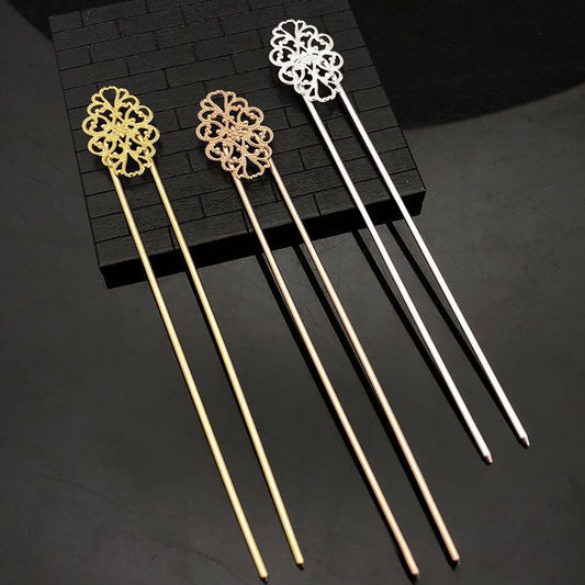 Set of 3 Chinese-style copper hair sticks with intricate floral filigree tops in gold, rose gold, and silver tones, displayed on black brick background