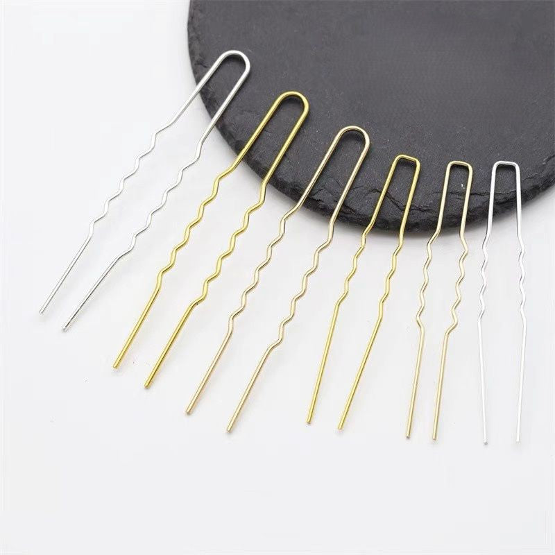 Set of U-shaped wavy copper hair pins, 75mm long, in gold and silver electroplated finish, zigzag wave design, displayed on black slate round plate