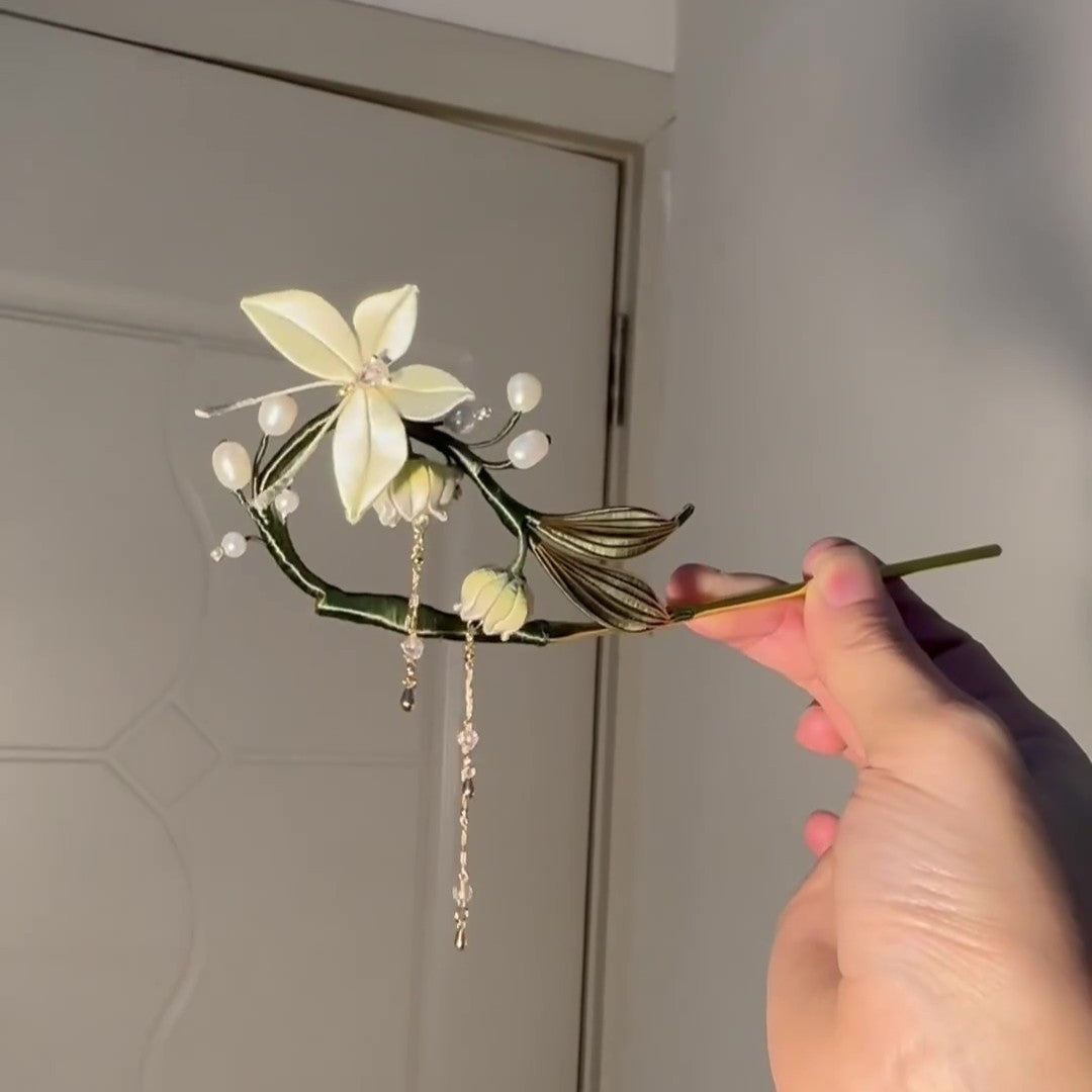 Handcrafted Chanhua hairpin featuring a white thread-wrapped butterfly and Lily of the Valley flowers with blue accents.