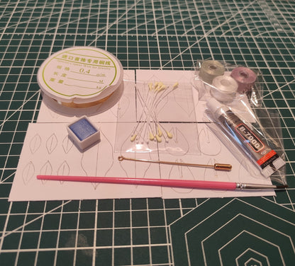 DIY flower craft supply kit including threads, wire, glue, blue shading powder, brush, and templates for making a Statice flower.