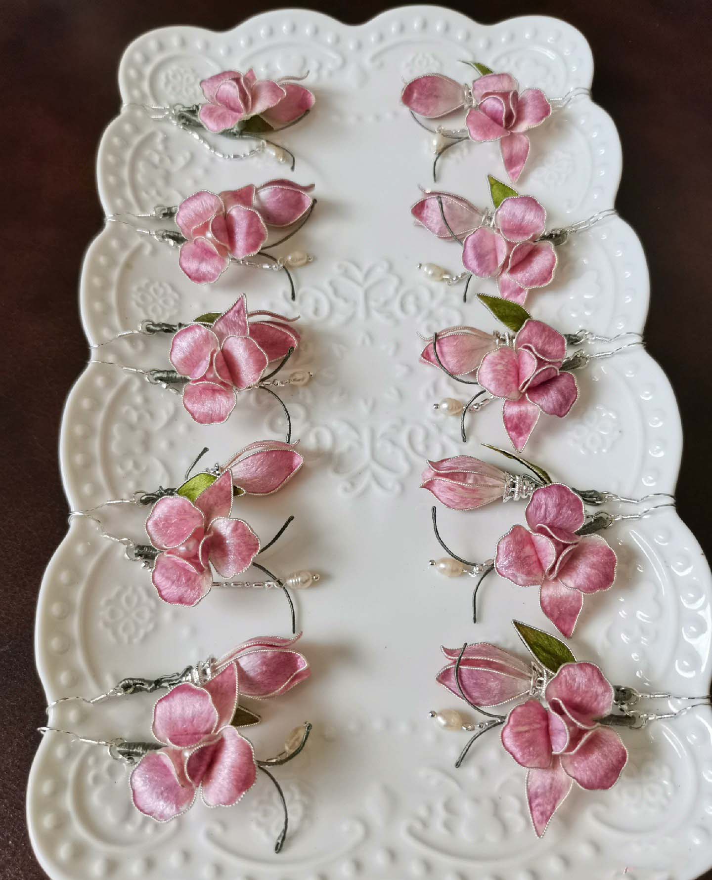 Natural silk Ronghua(velvet flower) earrings.A set of delicate floral-themed earrings, showcasing pink petals and green leaves design