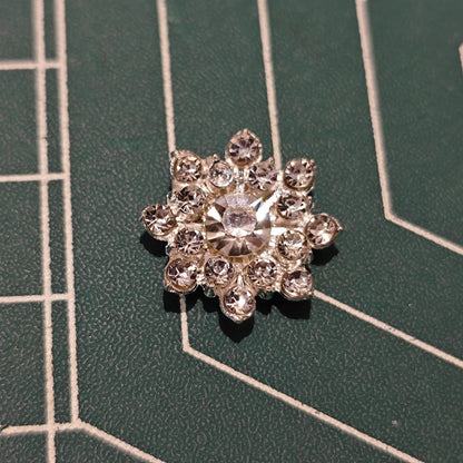 Close-up of Silver-Tone Snowflake Flower Center with Large Center Rhinestone and Clear Accents